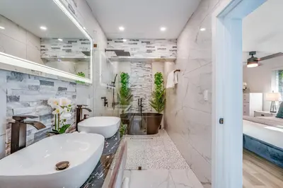 a white bathroom with a tub and a sink at Friendly Fox Luxury Pool & Spa House Near Downtown & Beach in Fort Lauderdale