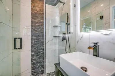 a white bathroom with a sink and a shower at Friendly Fox Luxury Pool & Spa House Near Downtown & Beach in Fort Lauderdale