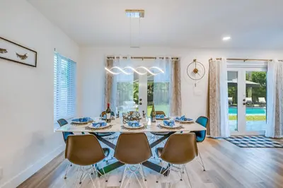 a dining room with a table and chairs at Friendly Fox Luxury Pool & Spa House Near Downtown & Beach in Fort Lauderdale