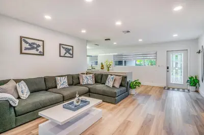 a living room with a couch and a table at Friendly Fox Luxury Pool & Spa House Near Downtown & Beach in Fort Lauderdale