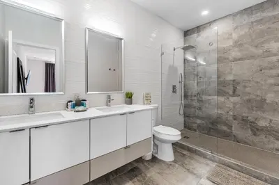 a white bathroom with a toilet and a shower at Fox Sonata Downtown Pool House in Fort Lauderdale