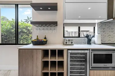 a kitchen with a counter with wine glasses at Fox Sonata Downtown Pool House in Fort Lauderdale