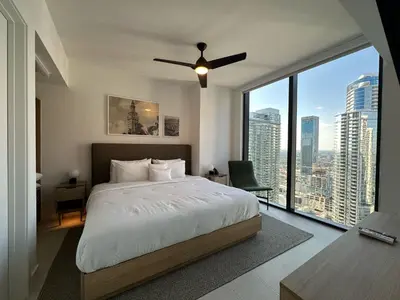 a bedroom with a large bed and a large window at Downtown Miami view - 38th floor gem in Miami