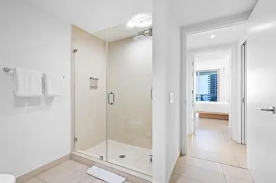 a bathroom with a shower with a glass door at Oceanfront Luxe Apt 24th Floor in Hollywood