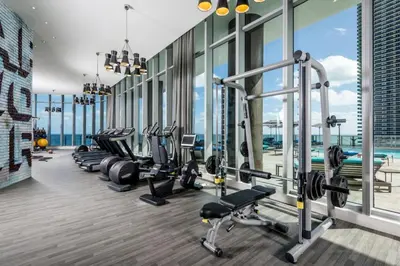 a gym with a row of treadmills and machines at Oceanfront Luxe Apt 24th Floor in Hollywood