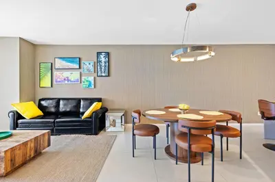 a living room with a table and a couch at Oceanfront Luxe Apt 24th Floor in Hollywood