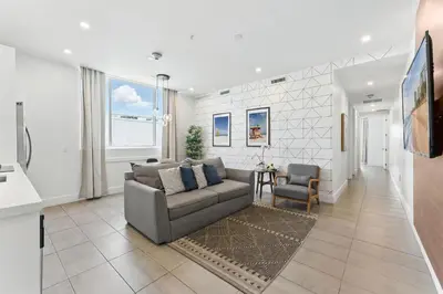 a living room with a couch and a table at South Beach Sleek 2BR Getaway in Miami Beach