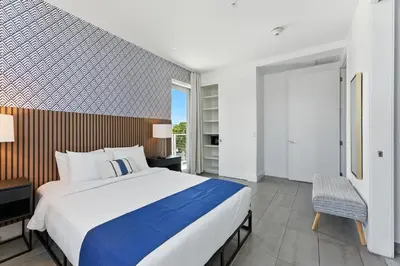a large bedroom with a large bed and a window at South Beach Sleek 2BR Getaway in Miami Beach