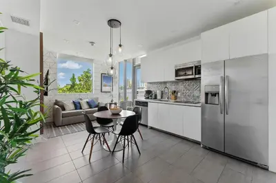 a kitchen and living room with a table and chairs at SoBe 2 Bedroom Near Ocean Drive in Miami Beach