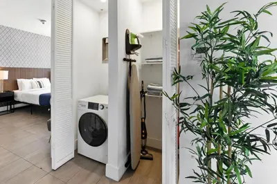 a bathroom with a washing machine in a room at South Beach Stylish 2BR Retreat in Miami Beach