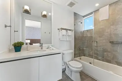a bathroom with a toilet and a sink and a shower at South Beach 2BR Paradise in Miami Beach