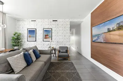 a living room with a couch and a large painting on the wall at South Beach 2BR Paradise in Miami Beach