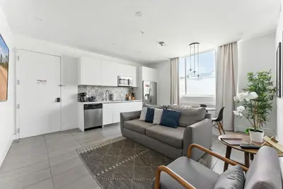 a living room with a couch and a kitchen at South Beach 2BR Paradise in Miami Beach