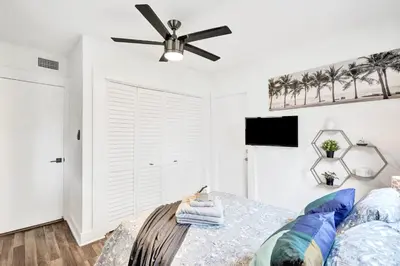 a bedroom with a ceiling fan and a bed at Trendy 4 Bedroom Pool Home Minutes from the Beach in Hollywood