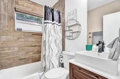 a bathroom with a white toilet and a shower curtain at Trendy 4 Bedroom Pool Home Minutes from the Beach in Hollywood