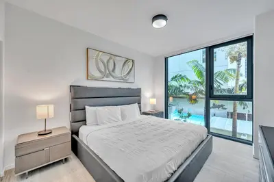 a bedroom with a bed and a large window at Amazing 3Beds 3Baths Corner Unit Downtown Miami in Miami