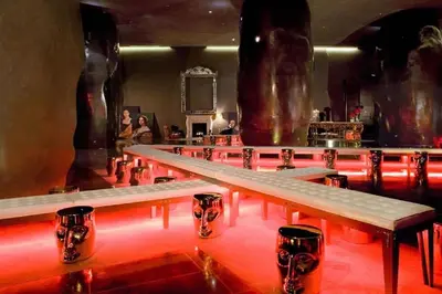 a row of tables in a room with red lights at 48th Floor ocean View Brickell in Miami