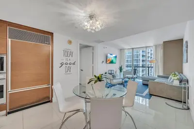 a living room with a glass table and a couch at 48th Floor ocean View Brickell in Miami