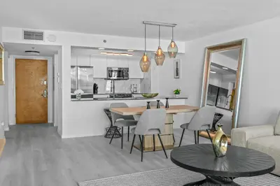 a living room and kitchen with a table and chairs at High Rise Unit in the heart of Brickell in Miami