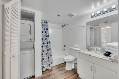 a white bathroom with a toilet and a sink at Superb private unit with amenities and parking in Miami