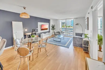 a living room with a table and chairs and a dining room at Superb private unit with amenities and parking in Miami