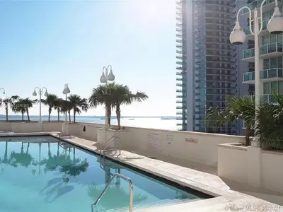 a swimming pool with a view of the ocean at Amazing unit location with amenities & parking in Miami