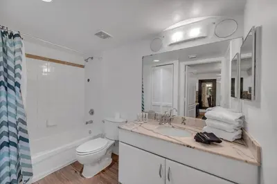 a white bathroom with a toilet and a sink at Amazing unit location with amenities & parking in Miami