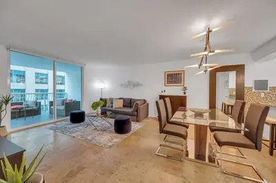 a dining room and living room with a dining table at Amazing unit location with amenities & parking in Miami