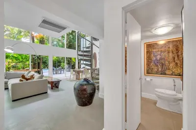 a living room with a large painting on the wall at Wonderful Tropical Pool House Miami Coconut Grove in Miami