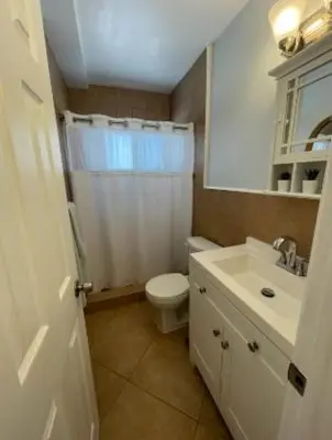 a bathroom with a white toilet and a sink at Modern Beachfront Suite at Hollywood Broadwalk in Hollywood