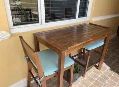 a wooden table with two chairs and a window at Modern Beachfront Suite at Hollywood Broadwalk in Hollywood