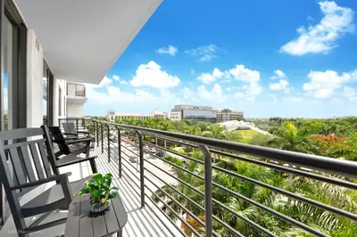 a balcony with a bench and a view of the city at Stylish 3BD-3BR at the Heart of Downtown Doral with Top Amenities & Golf in Miami