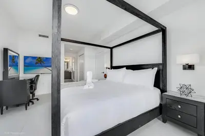a bedroom with a bed and a desk and a computer at Stylish 3BD-3BR at the Heart of Downtown Doral with Top Amenities & Golf in Miami