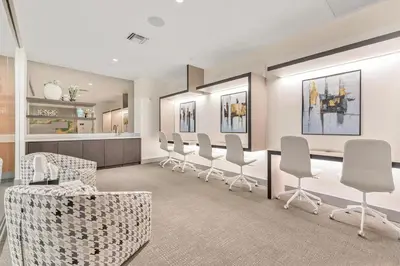 a waiting room with a row of chairs and a counter at Stylish 3BD-3BR at the Heart of Downtown Doral with Top Amenities & Golf in Miami