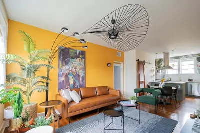 a living room with a couch and a yellow wall at Stylish 2br apt, king-size bed, 5mins to the beach - J3 in Hollywood