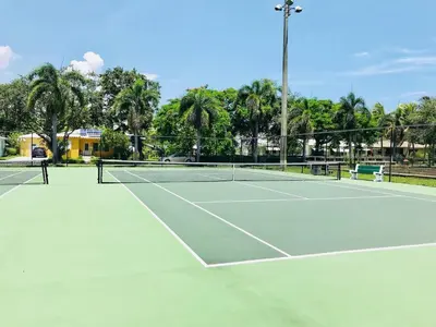 a tennis court with two tennis rackets on it at Stylish 2br apt, king-size bed, 5mins to the beach - J3 in Hollywood