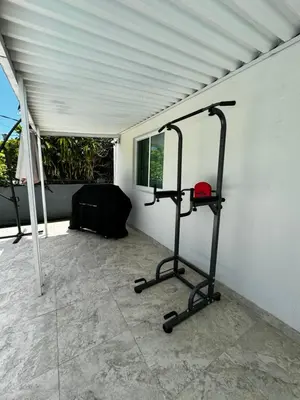 a room with a gym with a treadmill at Casita with pool, laundry and FREE parking in Miami
