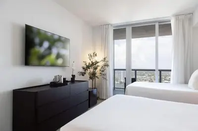 a bedroom with two beds and a large window at 2 Bed & 2 Bath at Beachwalk - Amazing View on 29th in Hallandale Beach