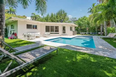 a backyard with a swimming pool and a house at Secluded Villa with 3 bedrooms and Heated Pool in Miami Beach