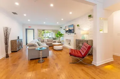 a living room with a couch and a fireplace at Secluded Villa with 3 bedrooms and Heated Pool in Miami Beach