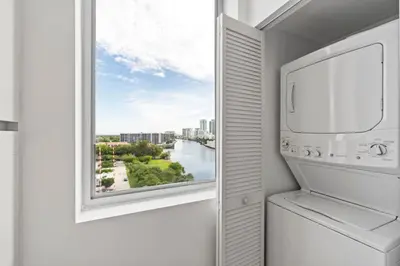 a kitchen with a window with a view of a river at WATERFRONT Luxury 3 Bed 3 Bath Suite in Hallandale Beach