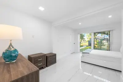 a white living room with a couch and a table at Fort Lauderdale Water Front Oasis in Fort Lauderdale