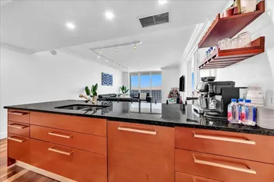 a large kitchen with a counter top and a stove at South City Suites in Hallandale Beach