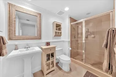 a bathroom with a toilet and a sink and a shower at South City Suites in Hallandale Beach