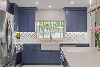 a kitchen with blue cabinets and a window at Modern Hollywood 3BR House Pool Jacuzzi in Hollywood