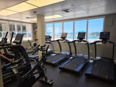 a gym with treadmills and elliptical machines at Lujoso Departamento Con VIstas Al Mar- Miami Beach in Sunny Isles Beach