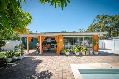 a house with a patio and a swimming pool at 3-Bedroom Tropical Villa with Heated Pool in Fort Lauderdale in Fort Lauderdale
