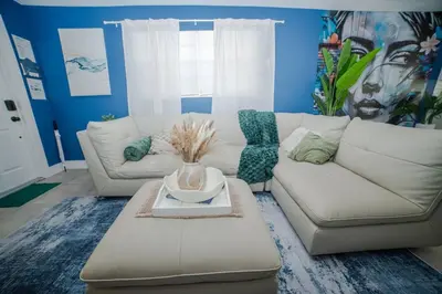 a living room with a white couch and a table at 3-Bedroom Tropical Villa with Heated Pool in Fort Lauderdale in Fort Lauderdale