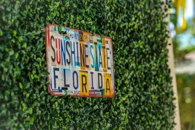 a sign is attached to a bush at 3-Bedroom Tropical Villa with Heated Pool in Fort Lauderdale in Fort Lauderdale