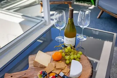 a bottle of wine and wine glasses on a table at Champagne at Tiffany's - Luxury Condo by the Beach in Fort Lauderdale